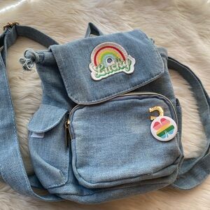blue denim mini backpack with a "Lucky"